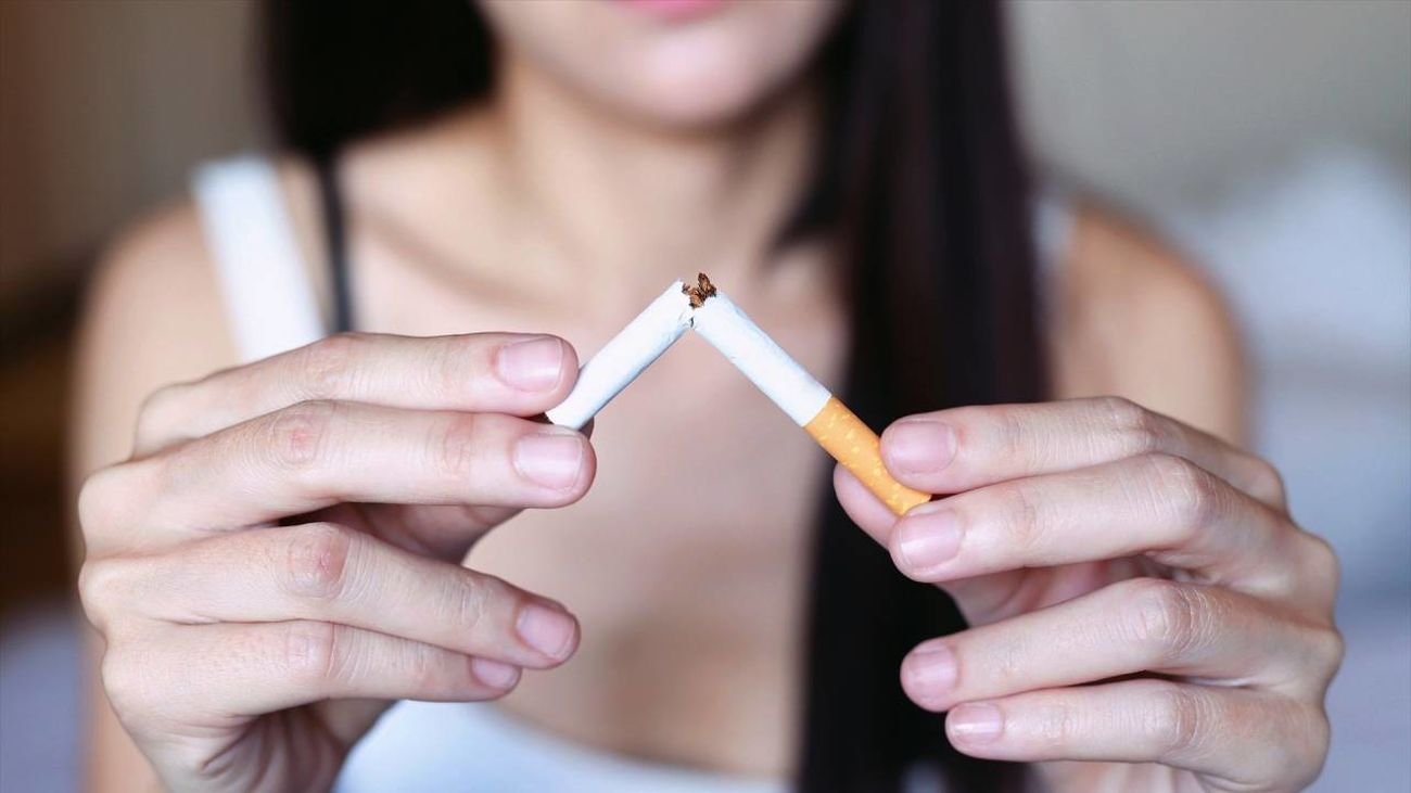 Una chica rompe un cigarrillo por la mitad